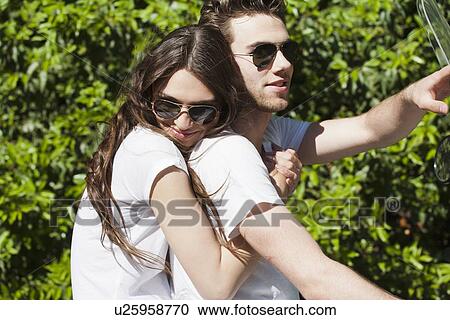 Smiling couple on scooter View Large Photo Image Stock Image - Smiling couple on scooter. Fotosearch
