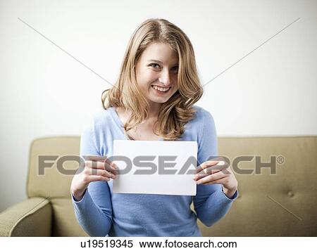 Smiling woman holding white page View Large Photo Image Stock Photography - Smiling woman holding white page. Fotosearch