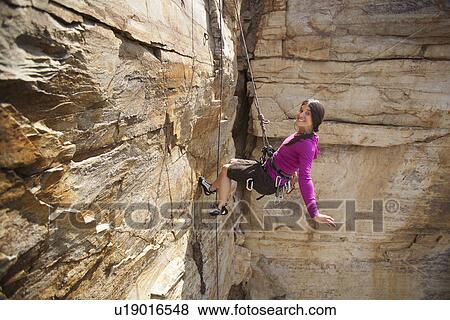 Smiling woman rock climbing View Large Photo Image Stock Photo - Smiling woman rock climbing. Fotosearch