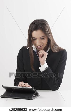 Smiling young woman using digital tablet View Large Photo Image Stock Image - Smiling young woman using digital tablet. Fotosearch