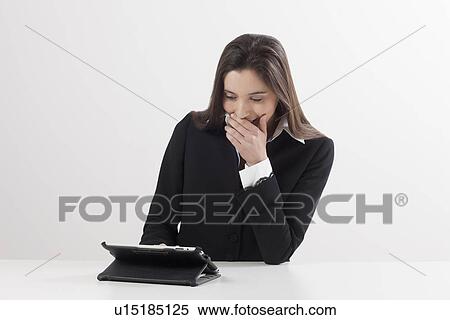 Smiling young woman using digital tablet View Large Photo Image Stock Photography - Smiling young woman using digital tablet. Fotosearch