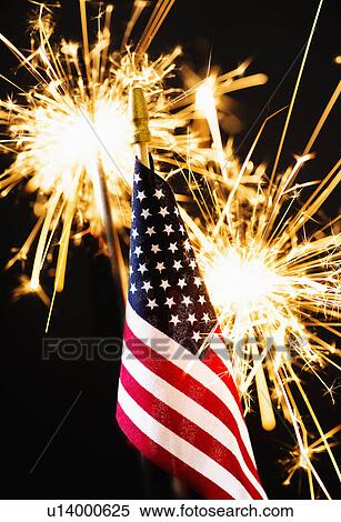 Stock Photography - Sparkler and American flag an black background. Fotosearch
