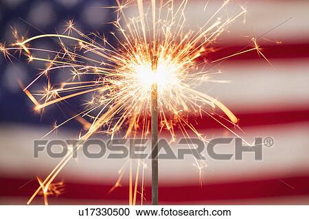Stock Image - Sparkler and American flag. Fotosearch