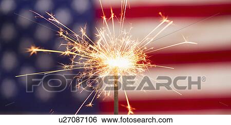 Stock Photograph - Sparkler and American flag. Fotosearch
