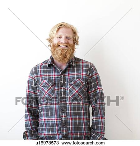 Stock Image - Studio portrait of man with beard. Fotosearch