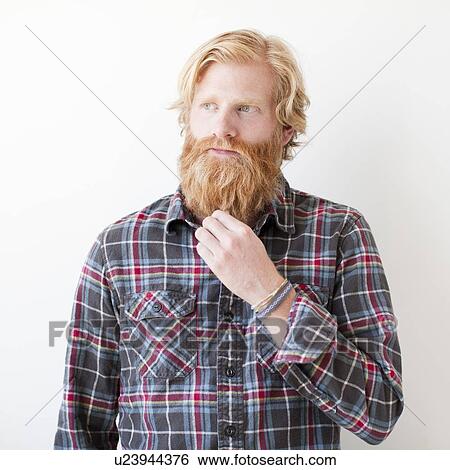 Stock Photograph - Studio portrait of man with beard. Fotosearch