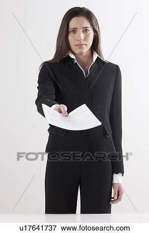 Studio shot of businesswoman holding document View Large Photo Image Stock Photo - Studio shot of businesswoman holding document. Fotosearch