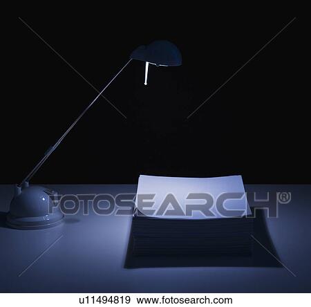 Studio shot of desk lamp and stack of documents View Large Photo Image Stock Photo - Studio shot of desk lamp and stack of documents. Fotosearch