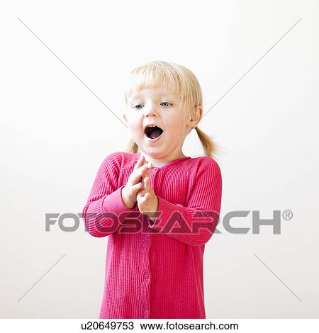 Stock Image - Studio shot of girl (2-3) clapping hands. Fotosearch