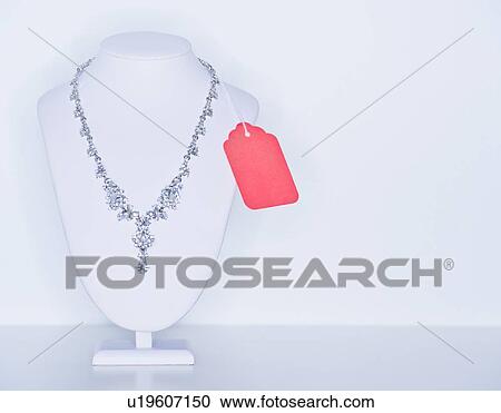 Stock Image - Studio shot of necklace on jewelry stands. Fotosearch