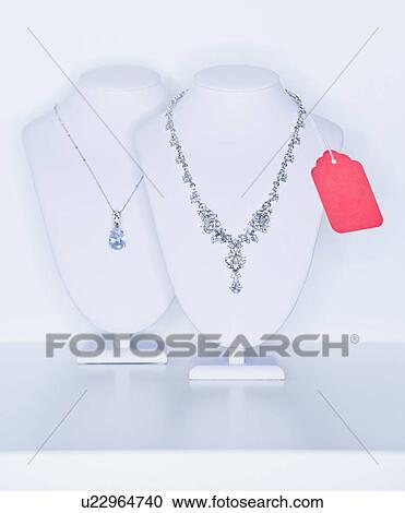 Stock Image - Studio shot of necklaces on jewelry stands. Fotosearch