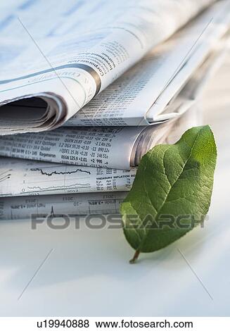 Studio shot of newspaper and green leaf View Large Photo Image Stock Photo - Studio shot of newspaper and green leaf. Fotosearch