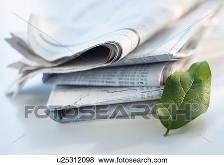 Studio shot of newspaper and green leaf View Large Photo Image Stock Photo - Studio shot of newspaper and green leaf. Fotosearch