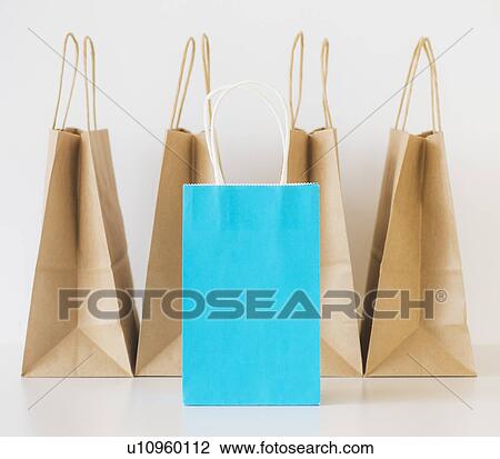Stock Image - Studio shot of shopping bags and note book. Fotosearch