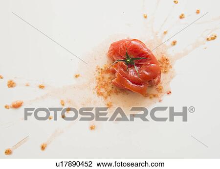 Stock Image - Studio Shot of smashed tomato. Fotosearch
