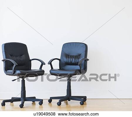 Studio shot of two black office chairs View Large Photo Image Stock Photo - Studio shot of two black office chairs. Fotosearch