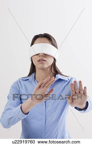 Studio shot of woman wearing blindfold View Large Photo Image Stock Image - Studio shot of woman wearing blindfold. Fotosearch