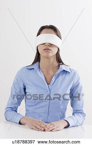 Stock Photo - Studio shot of woman wearing blindfold. Fotosearch