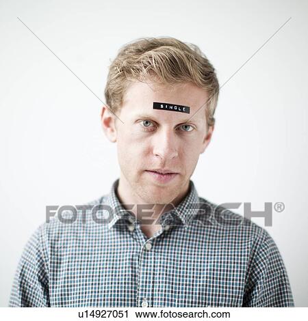 Studio shot of young man with word 'single' on forehead View Large Photo Image Stock Image - Studio shot of young man with word 'single' on forehead. Fotosearch