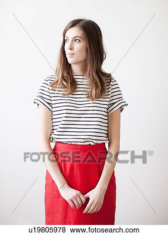 Studio shot of young woman looking away View Large Photo Image Stock Photo - Studio shot of young woman looking away. Fotosearch