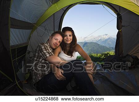 Stock Photo - Switzerland, Leysin, Hikers embracing in tent. Fotosearch