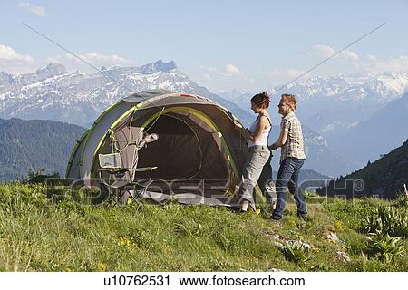 Switzerland, Leysin, Hikers pitching tent on meadow View Large Photo Image Stock Image - Switzerland, Leysin, Hikers pitching tent on meadow. Fotosearch
