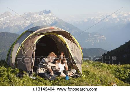 Switzerland, Leysin, Hikers preparing breakfast on Alpine meadow View Large Photo Image Picture - Switzerland, Leysin, Hikers preparing breakfast on Alpine meadow. Fotosearch