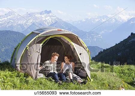 Switzerland, Leysin, Hikers resting in tent pitched on meadow View Large Photo Image Stock Image - Switzerland, Leysin, Hikers resting in tent pitched on meadow. Fotosearch