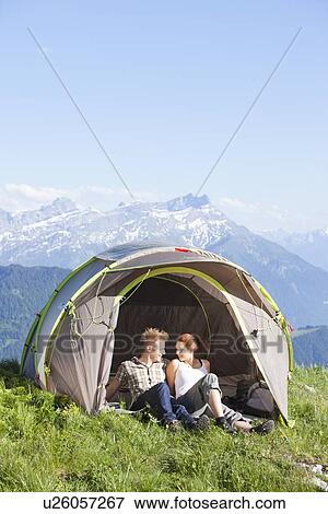 Switzerland, Leysin, Hikers resting in tent pitched on meadow View Large Photo Image Stock Photo - Switzerland, Leysin, Hikers resting in tent pitched on meadow. Fotosearch