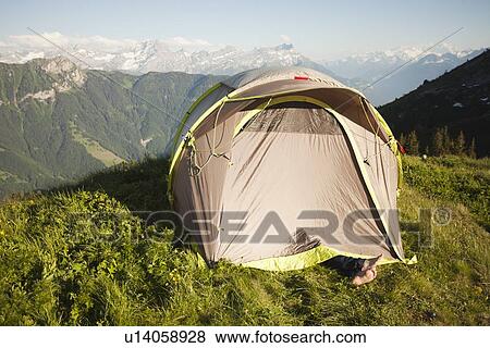 Stock Photo - Switzerland, Leysin, Tent pitched on Alpine meadow. Fotosearch