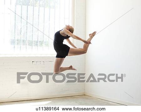 Teenage (16-17) gymnast exercising View Large Photo Image Picture - Teenage (16-17) gymnast exercising. Fotosearch