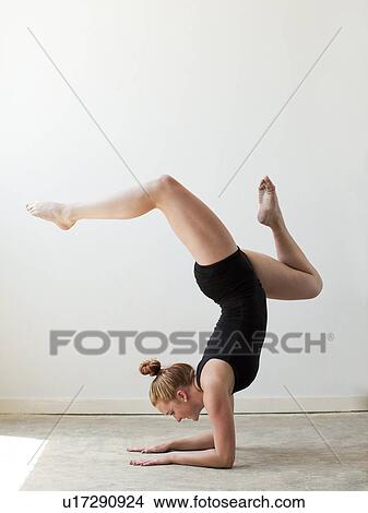 Teenage (16-17) gymnast exercising View Large Photo Image Picture - Teenage (16-17) gymnast exercising. Fotosearch
