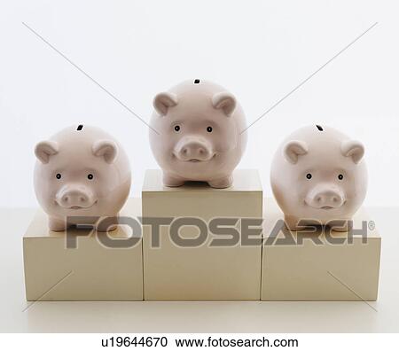 Stock Image - Three piggy banks in arranged on sports podium. Fotosearch