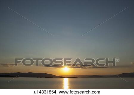Picture - USA, Montana, Flathead Lake, View of sunset over lake. Fotosearch