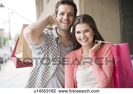 USA, New Jersey, Jersey City, Happy young couple shopping View Large Photo Image Stock Image - USA, New Jersey, Jersey City, Happy young couple shopping. Fotosearch