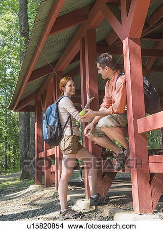 Picture - USA, New Jersey, Mendham, Couple resting during hiking in forest. Fotosearch