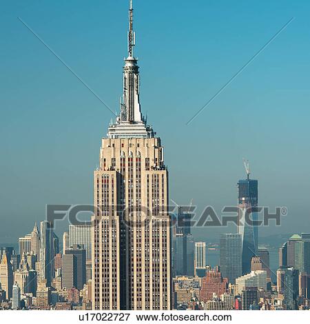 Stock Photo - USA, New York City, Empire State Building with Manhattan skyline in background. Fotosearch