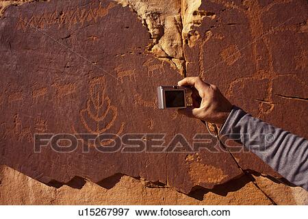 Stock Photo - USA, Utah, Native American art on stone wall. Fotosearch