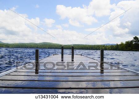 View of lake with wooden jetty View Large Photo Image Picture - View of lake with wooden jetty. Fotosearch