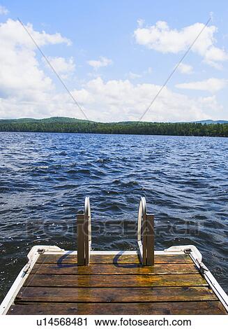 View of lake with wooden jetty View Large Photo Image Stock Image - View of lake with wooden jetty. Fotosearch