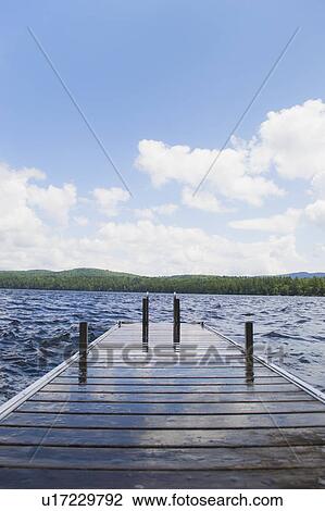 View of lake with wooden jetty View Large Photo Image Stock Image - View of lake with wooden jetty. Fotosearch
