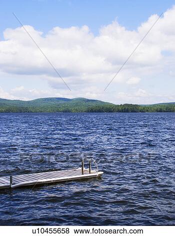 View of lake with wooden jetty View Large Photo Image Stock Photo - View of lake with wooden jetty. Fotosearch