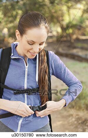 Woman adjusting backpack View Large Photo Image Stock Image - Woman adjusting backpack. Fotosearch