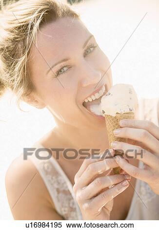 Stock Photography - Woman eating ice cream. Fotosearch