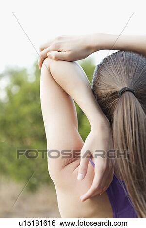 Woman exercising in park View Large Photo Image Stock Photograph - Woman exercising in park. Fotosearch