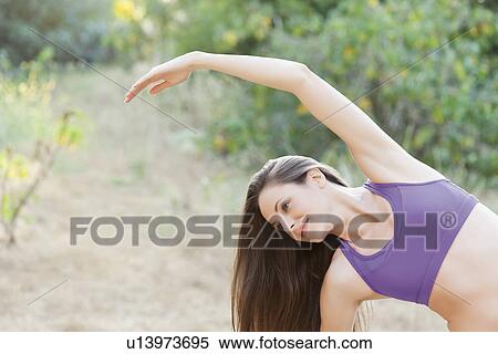 Stock Photography - Woman exercising in park. Fotosearch