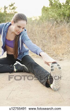Woman exercising on dusty track View Large Photo Image Stock Image - Woman exercising on dusty track. Fotosearch
