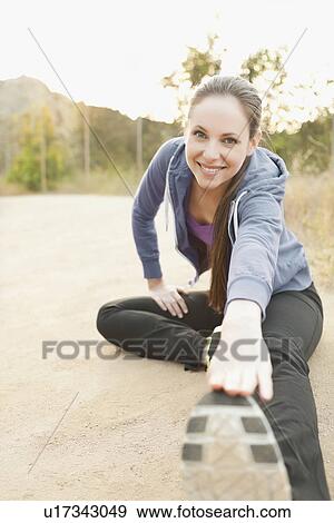 Woman exercising on dusty track View Large Photo Image Stock Photo - Woman exercising on dusty track. Fotosearch