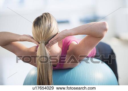 Woman exercising on fitness ball View Large Photo Image Stock Photo - Woman exercising on fitness ball. Fotosearch