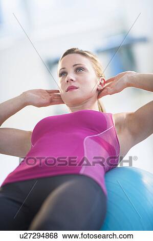 Woman exercising on fitness ball View Large Photo Image Stock Photo - Woman exercising on fitness ball. Fotosearch